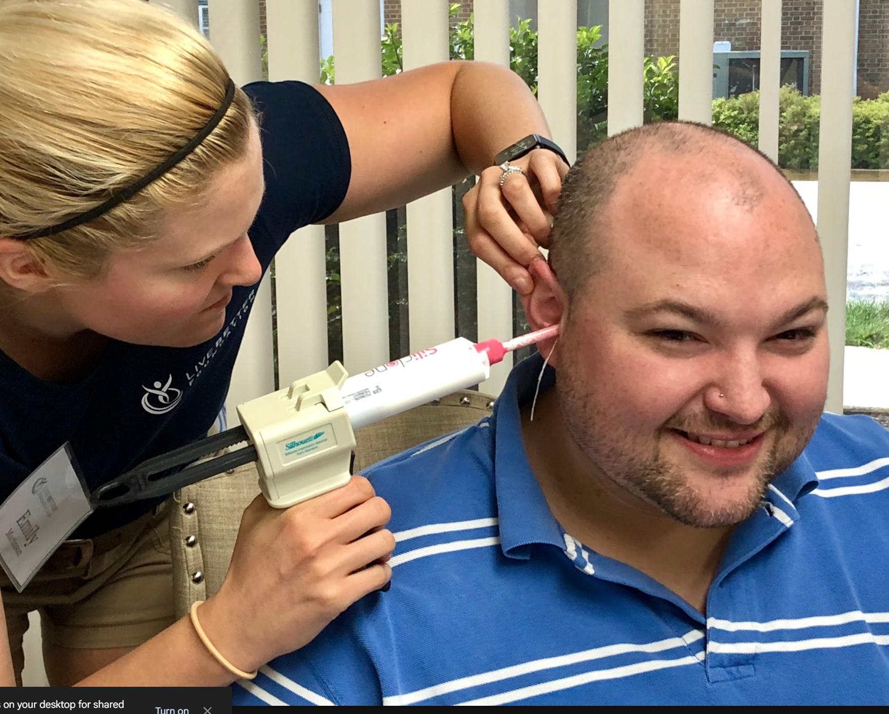 Doctor examining a patient's ear with an otoscope