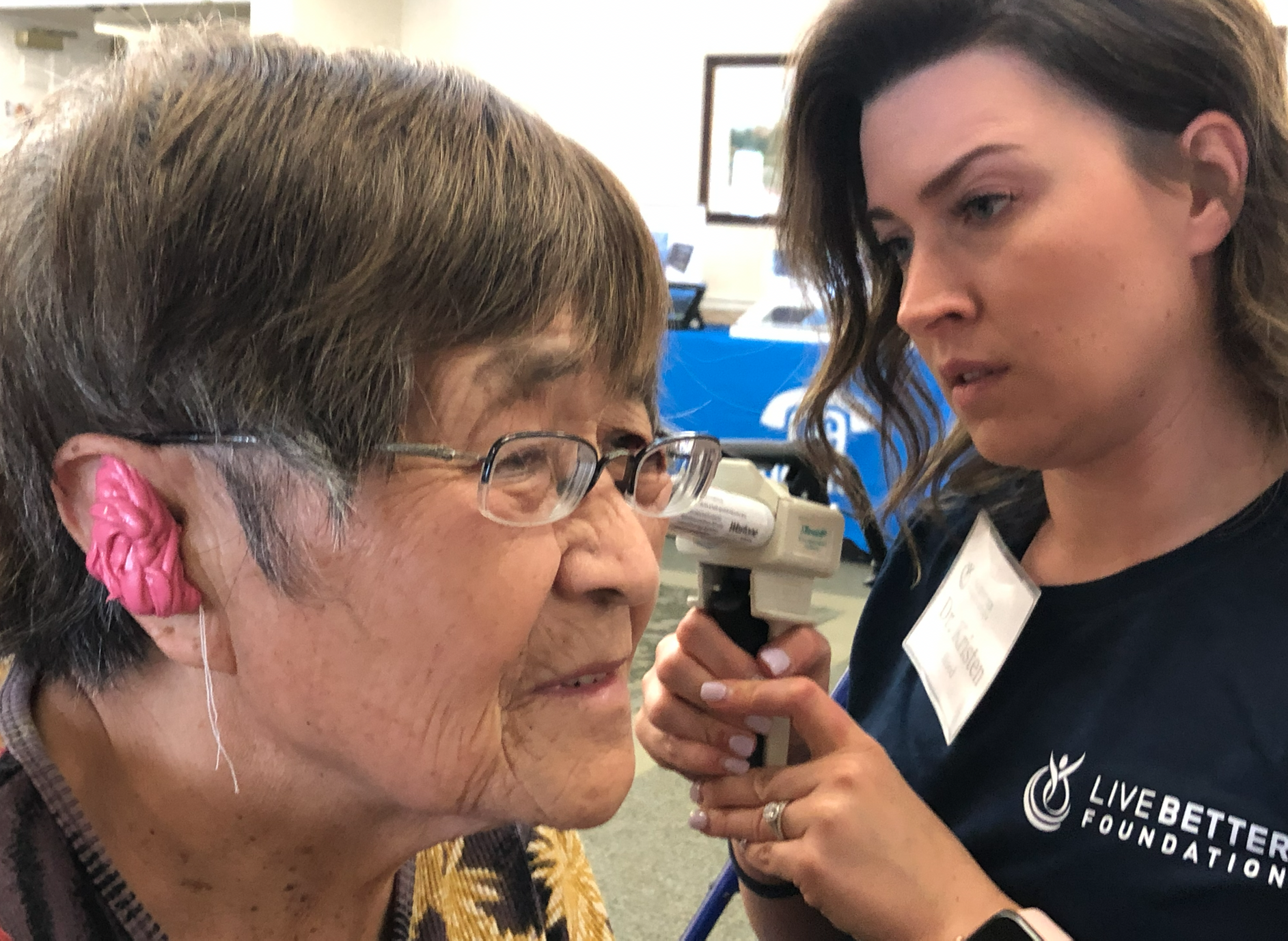 Volunteers and audiologists working together at a Live Better Foundation clinic event